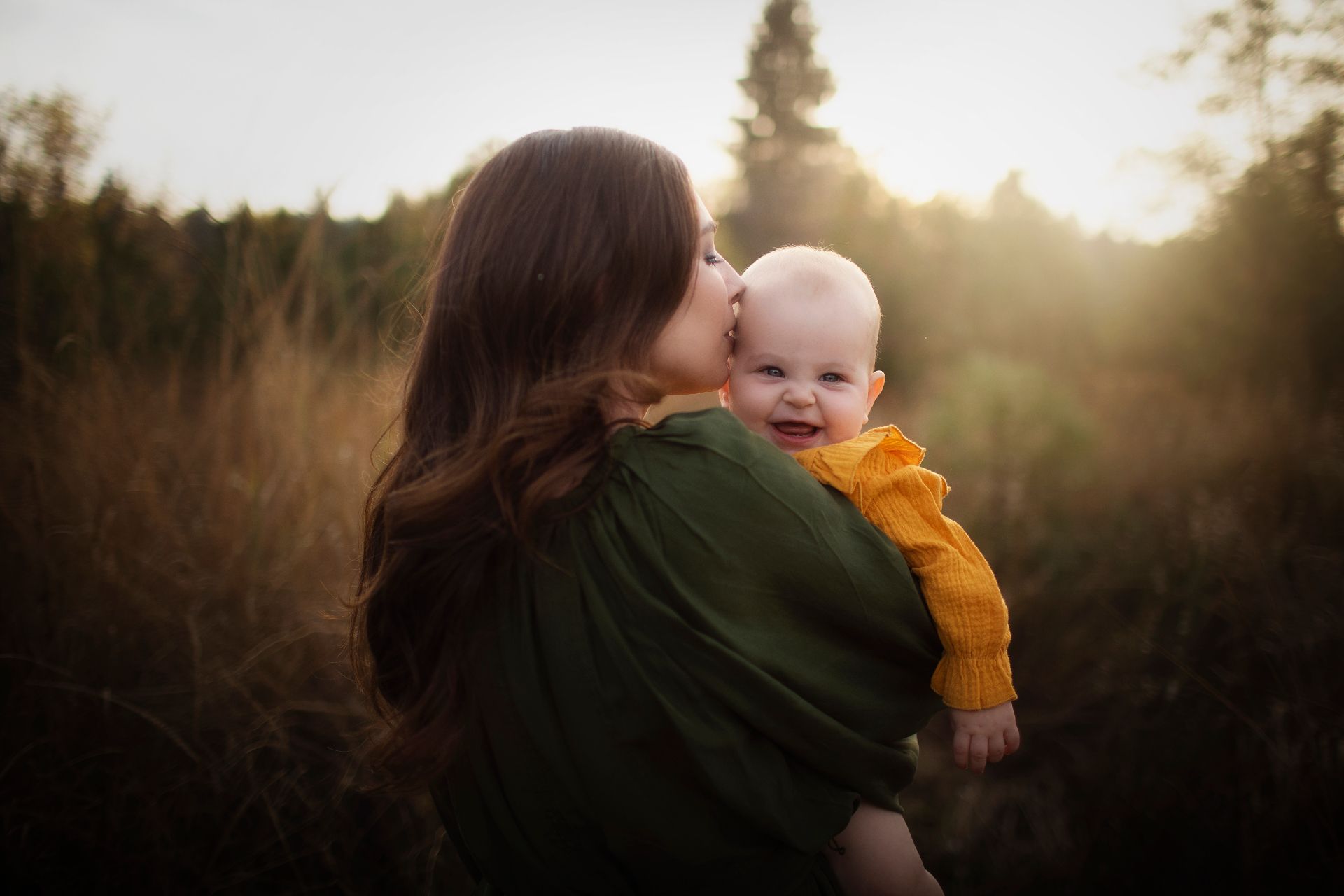 Mother kissing her child